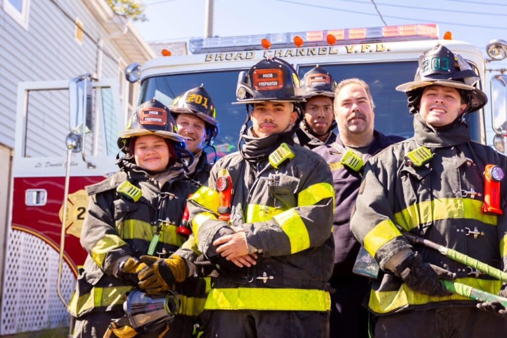 6 firefighters in front of engine truck